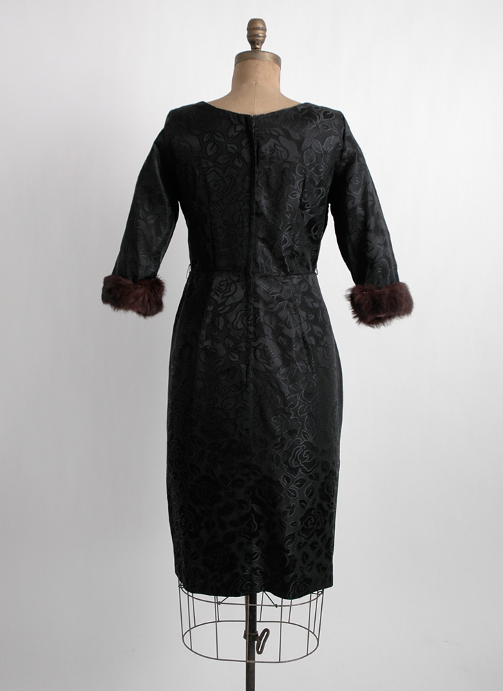 1960s black satin-y dress with fur cuffs